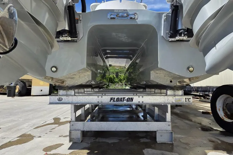 Hit N Run Yacht Photos Pics 2020 Invincible 35 Catamaran on trailer, showcasing hull design and outboard engines.