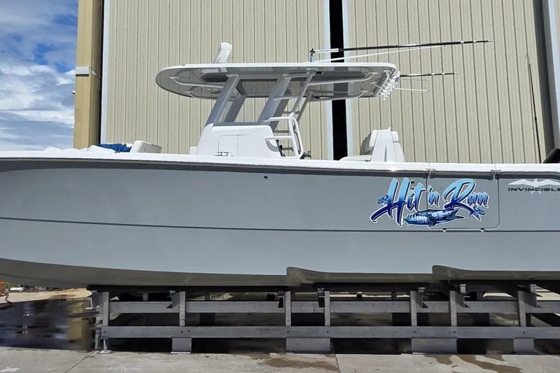 Hit N Run Yacht Photos Pics 2020 Invincible 35 Catamaran on dock, featuring "Hit'n Run" graphic.
