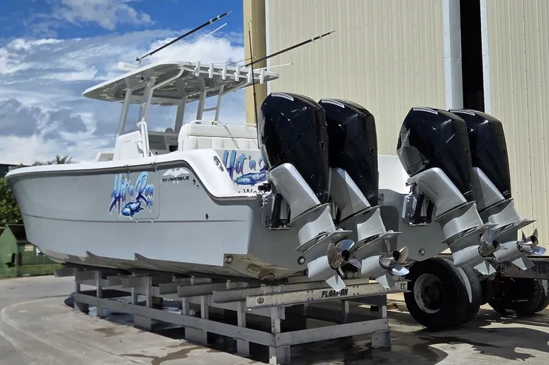 Hit N Run Yacht Photos Pics 2020 Invincible 35 Catamaran with quad engines on a trailer, ready for adventure.