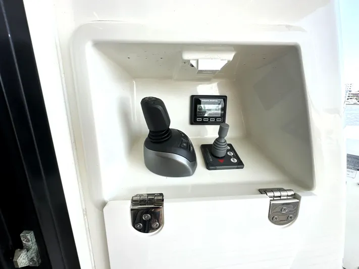 Perpetually Investing Yacht Photos Pics Control panel of a 2022 Prestige 520 yacht with joysticks and display.