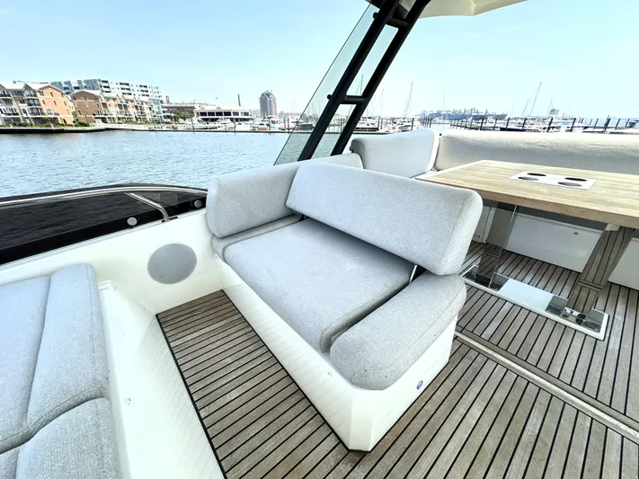 Perpetually Investing Yacht Photos Pics Luxurious 2022 Prestige 520 yacht with elegant seating and scenic marina view.