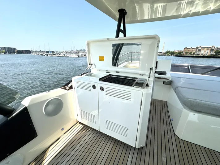 Perpetually Investing Yacht Photos Pics Prestige 520 yacht deck with outdoor kitchen, 2022 model, overlooking marina.