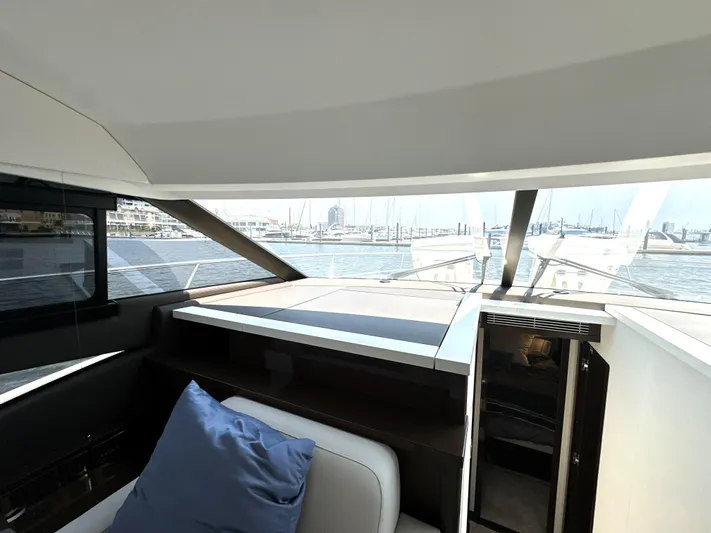 Perpetually Investing Yacht Photos Pics Interior view of 2022 Prestige 520 yacht with marina in background.