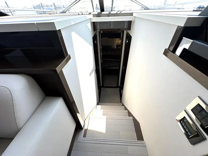 Perpetually Investing Yacht Photos Pics Staircase leading to lower deck of 2022 Prestige 520 yacht interior.