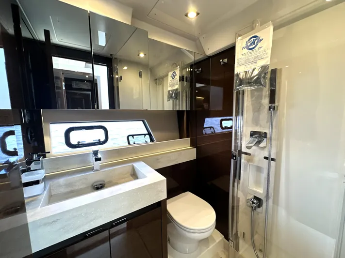 Perpetually Investing Yacht Photos Pics Luxurious bathroom in 2022 Prestige 520 yacht with modern fixtures and elegant design.