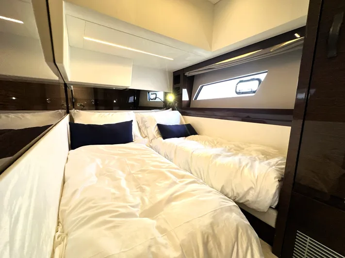 Perpetually Investing Yacht Photos Pics Luxurious cabin interior of 2022 Prestige 520 yacht with twin beds and modern design.