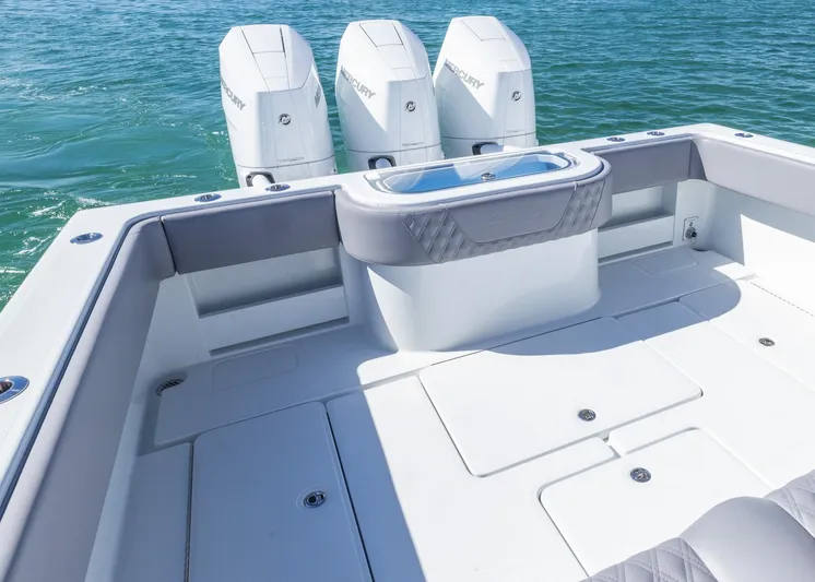  Yacht Photos Pics 2025 Invincible 39 Open Fisherman boat with triple outboard engines on clear water.