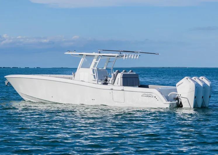  Yacht Photos Pics 2025 Invincible 39 Open Fisherman boat on calm ocean waters.