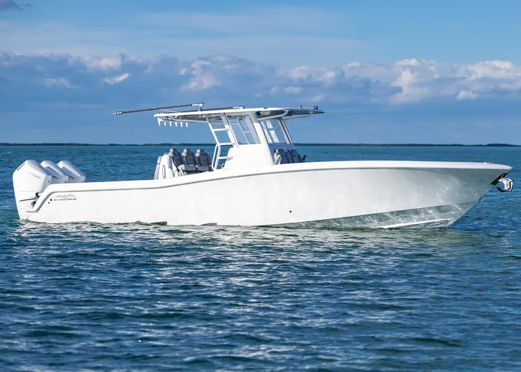  Yacht Photos Pics 2025 Invincible 39 Open Fisherman boat cruising on calm blue waters.