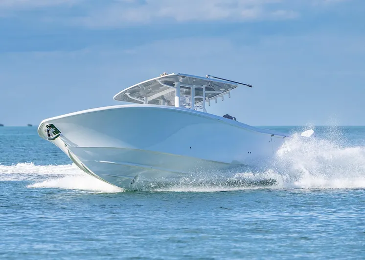  Yacht Photos Pics 2025 Invincible 39 Open Fisherman boat cruising on the ocean.