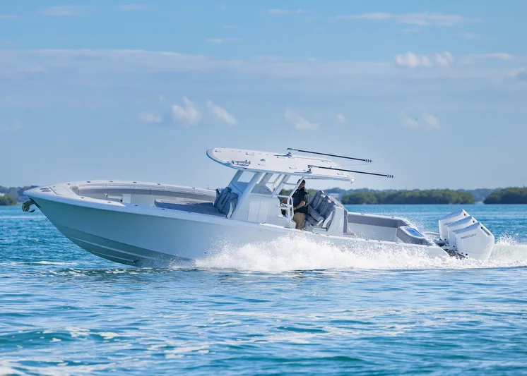  Yacht Photos Pics 2025 Invincible 39 Open Fisherman boat cruising on clear blue water.