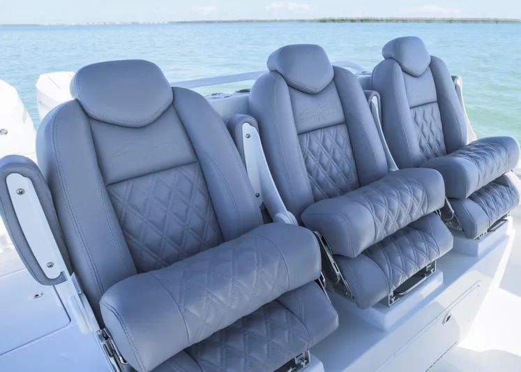  Yacht Photos Pics 2025 Invincible 39 Open Fisherman boat seats with diamond stitching, ocean backdrop.