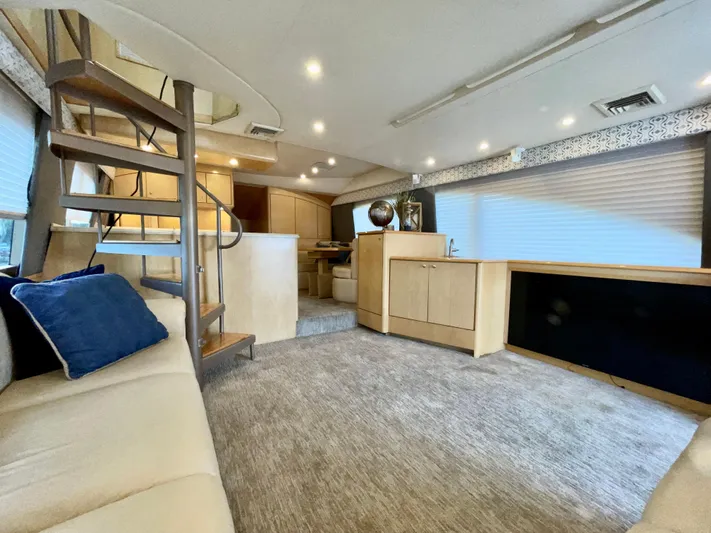 Snow Bank Yacht Photos Pics Luxurious interior of 2003 Ocean Yachts 62 Enclosed Bridge with modern furnishings and spiral staircase.