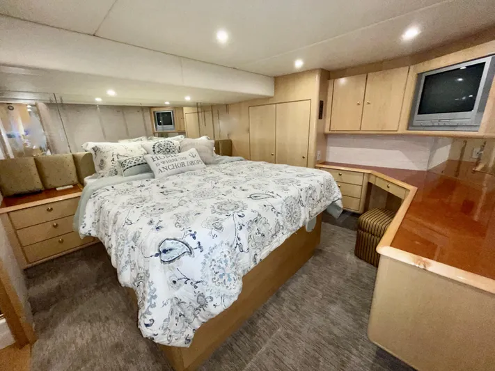 Snow Bank Yacht Photos Pics Luxurious bedroom interior of 2003 Ocean Yachts 62 Enclosed Bridge with elegant bedding and wood cabinetry.