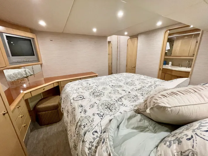 Snow Bank Yacht Photos Pics Luxurious bedroom interior of 2003 Ocean Yachts 62 Enclosed Bridge with elegant bedding and wood accents.