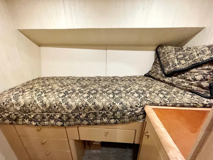 Snow Bank Yacht Photos Pics 2003 Ocean Yachts 62 Enclosed Bridge cabin with patterned bedding and wooden storage drawers.