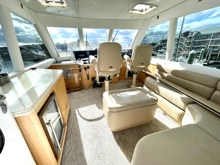 Snow Bank Yacht Photos Pics Luxurious interior of 2003 Ocean Yachts 62 Enclosed Bridge with plush seating and helm.