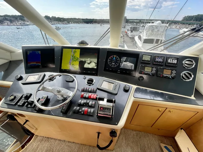 Snow Bank Yacht Photos Pics Helm of 2003 Ocean Yachts 62 Enclosed Bridge with navigation screens and controls.