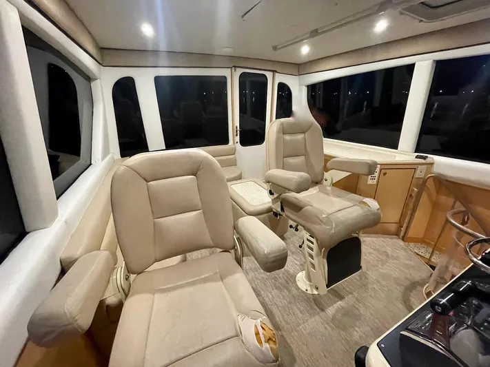 Snow Bank Yacht Photos Pics Luxurious interior of 2003 Ocean Yachts 62 Enclosed Bridge with plush seating and panoramic windows.