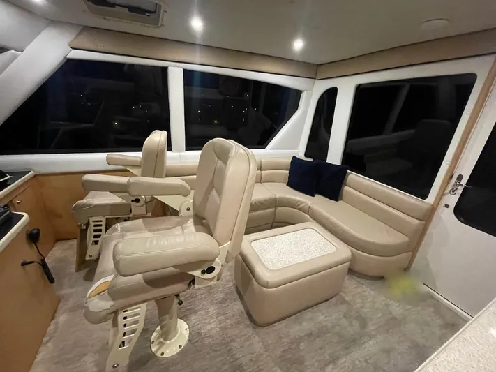 Snow Bank Yacht Photos Pics Luxurious interior of 2003 Ocean Yachts 62 Enclosed Bridge with plush seating and helm chairs.
