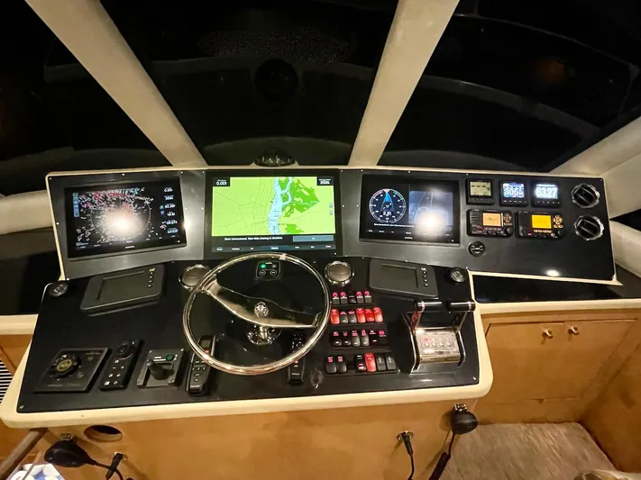Snow Bank Yacht Photos Pics Helm of 2003 Ocean Yachts 62 Enclosed Bridge with navigation screens and controls.