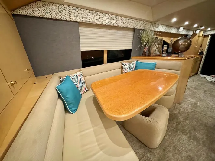 Snow Bank Yacht Photos Pics Luxurious interior of 2003 Ocean Yachts 62 Enclosed Bridge with elegant dining area.