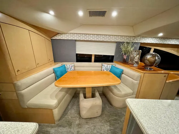 Snow Bank Yacht Photos Pics Luxurious dining area in 2003 Ocean Yachts 62 Enclosed Bridge with cozy seating and elegant decor.