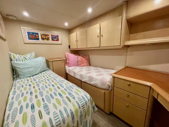 Snow Bank Yacht Photos Pics Cozy cabin interior of 2003 Ocean Yachts 62 Enclosed Bridge with twin beds and storage.