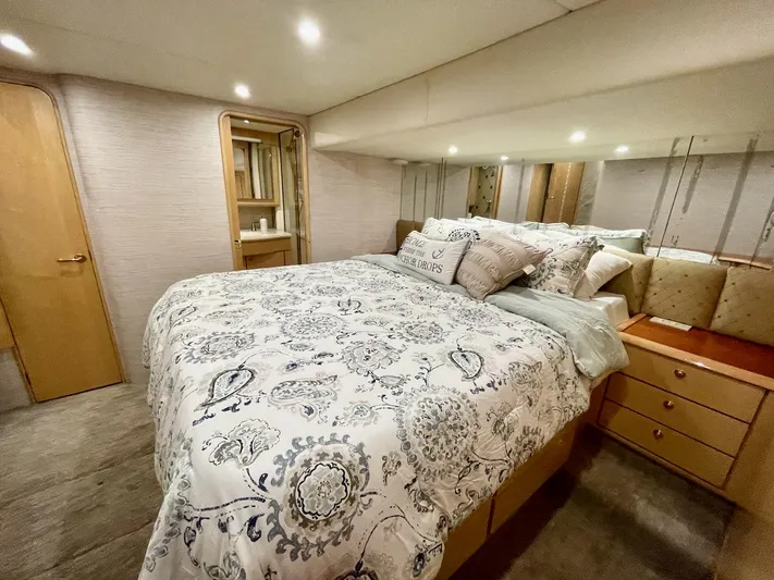 Snow Bank Yacht Photos Pics Luxurious bedroom interior of 2003 Ocean Yachts 62 Enclosed Bridge with elegant bedding.