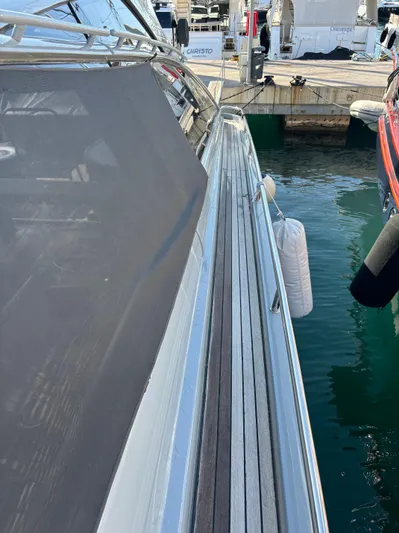  Yacht Photos Pics 2005 Baia Atlantica 78 yacht docked at marina, side view with water reflection.