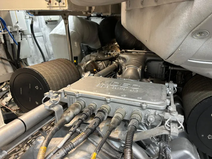  Yacht Photos Pics Engine compartment of a 2005 Baia Atlantica 78 yacht, showcasing mechanical components and wiring.