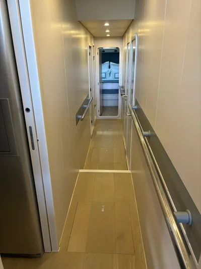  Yacht Photos Pics Narrow hallway inside 2005 Baia Atlantica 78 yacht, featuring sleek design and modern lighting.