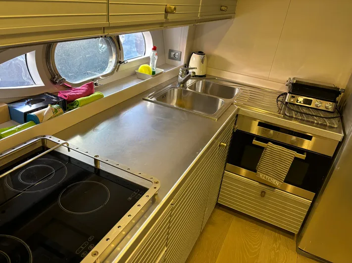  Yacht Photos Pics Modern kitchen in 2005 Baia Atlantica 78 yacht with stainless steel appliances and porthole window.