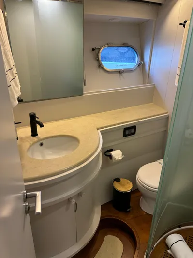  Yacht Photos Pics Luxurious bathroom in 2005 Baia Atlantica 78 yacht with modern fixtures and porthole window.