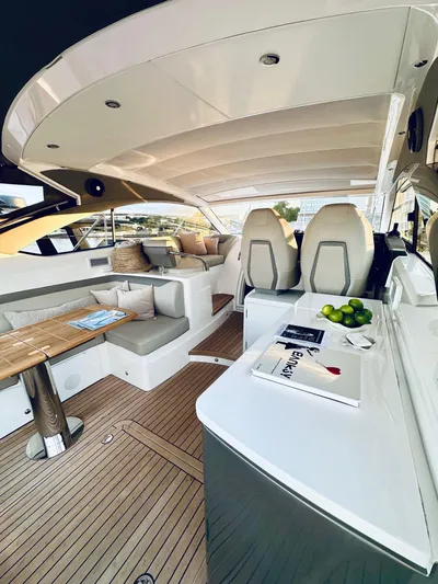 Rascal Yacht Photos Pics Luxurious 2024 Princess V40 yacht interior with elegant seating and modern amenities.