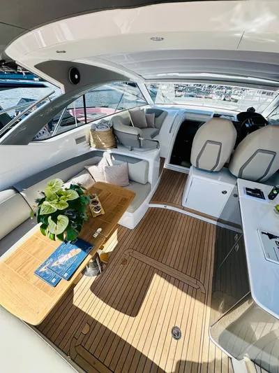 Rascal Yacht Photos Pics Luxurious 2024 Princess V40 yacht interior with elegant seating and wooden flooring.