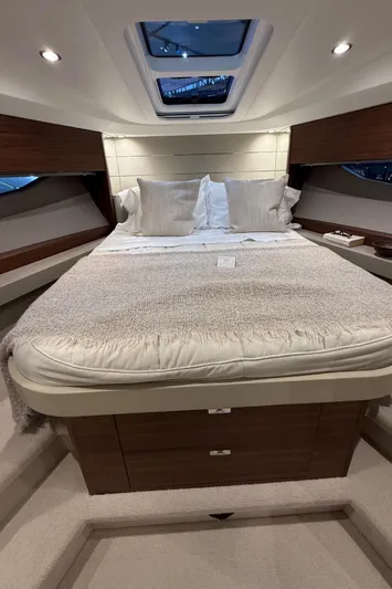 Rascal Yacht Photos Pics Luxurious 2024 Princess V40 yacht cabin with plush bedding and modern design.