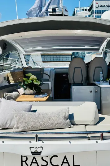 Rascal Yacht Photos Pics 2024 Princess V40 yacht interior with seating, cushions, and decor.