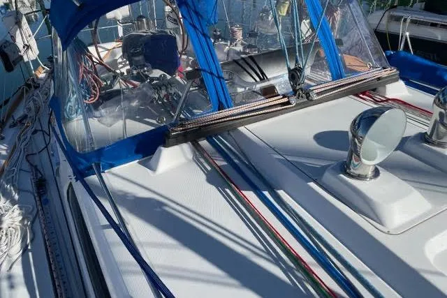 White Rose Yacht Photos Pics 2003 Sabre 426 sailboat deck with blue canopy and colorful rigging lines.