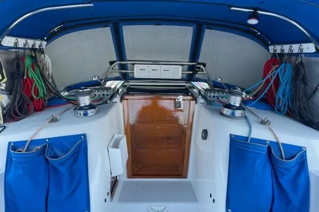 White Rose Yacht Photos Pics Interior view of a 2003 Sabre 426 sailboat cockpit with blue accents and organized ropes.
