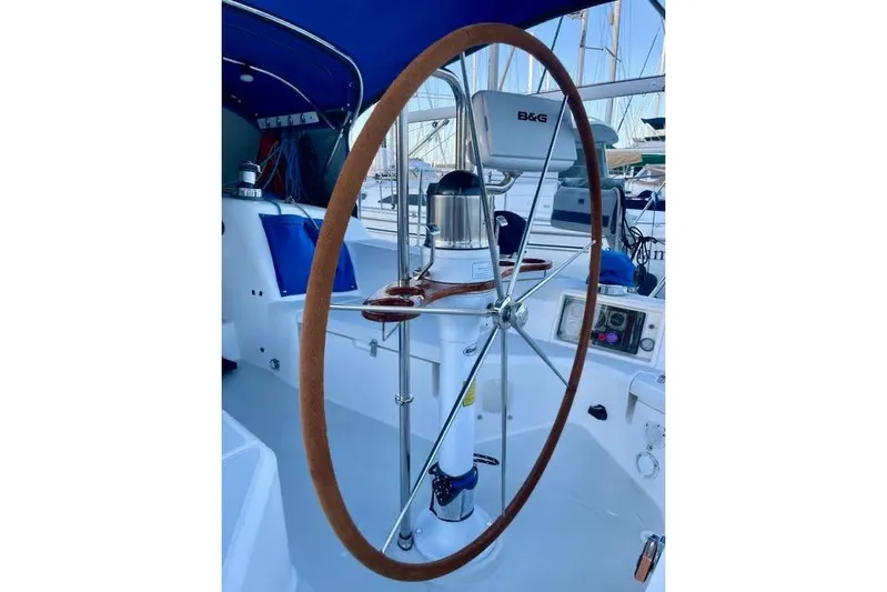 White Rose Yacht Photos Pics Steering wheel of a 2003 Sabre 426 sailboat, featuring navigation equipment.