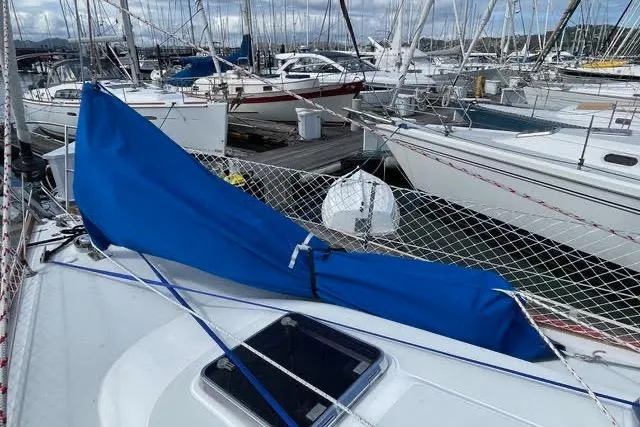 White Rose Yacht Photos Pics 2003 Sabre 426 sailboat docked, featuring a blue sail cover and marina background.