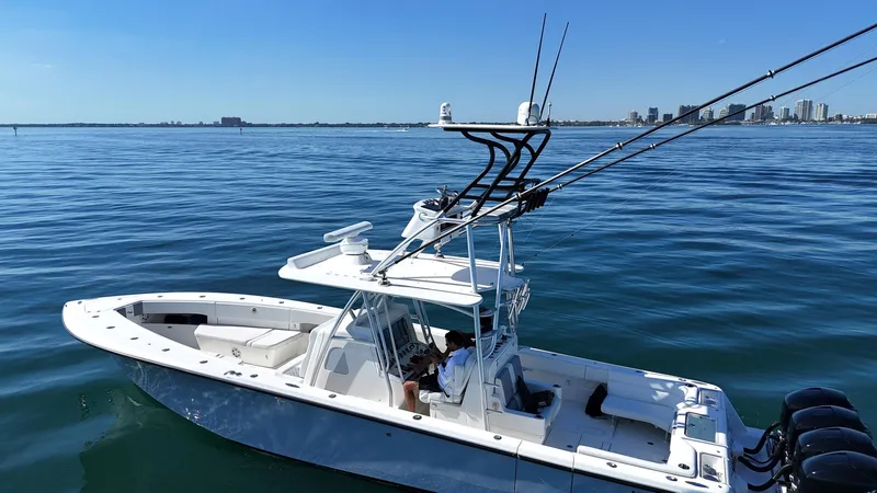 Simply Knot II Yacht Photos Pics 2018 SeaVee 390Z boat on calm water with city skyline in background.