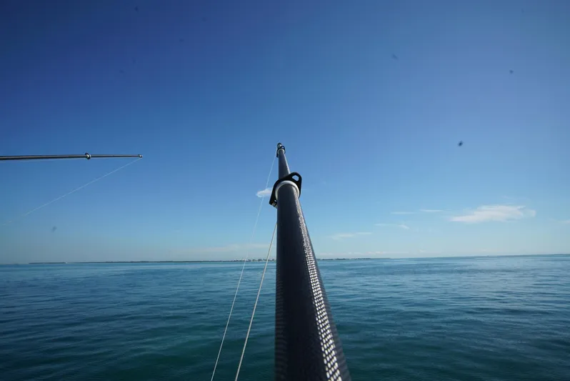 Simply Knot II Yacht Photos Pics Fishing rod on a 2018 SeaVee 390Z boat against a clear blue ocean and sky.