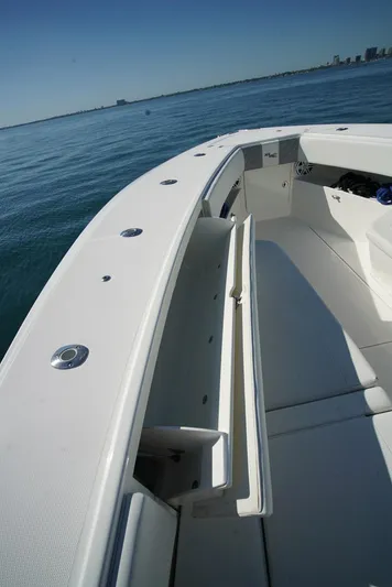 Simply Knot II Yacht Photos Pics 2018 SeaVee 390Z boat interior with open storage compartment on calm water.