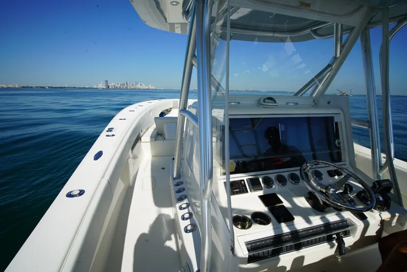 Simply Knot II Yacht Photos Pics 2018 SeaVee 390Z boat interior with steering console, navigating calm waters.