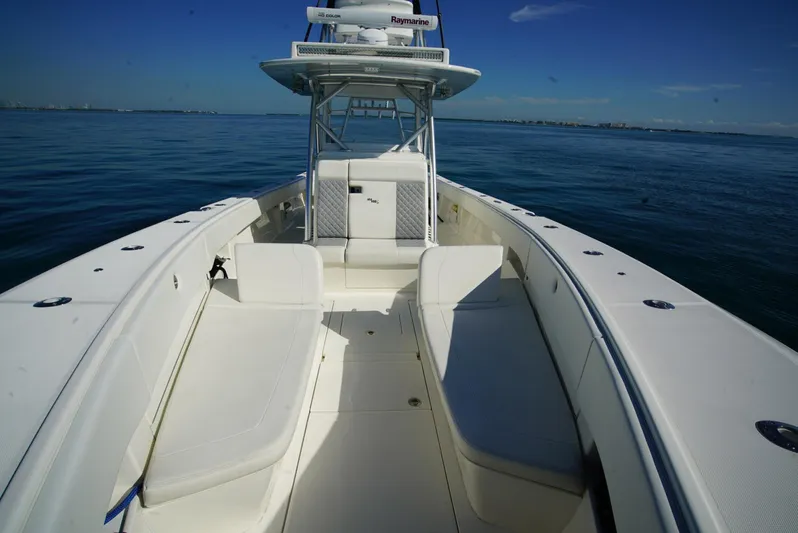 Simply Knot II Yacht Photos Pics 2018 SeaVee 390Z boat with spacious deck, white seating, and clear blue ocean backdrop.