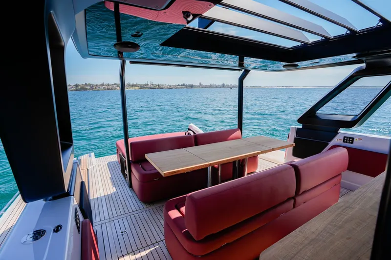  Yacht Photos Pics Luxurious interior of 2025 Cranchi A46 Luxury Tender with red seating and ocean view.