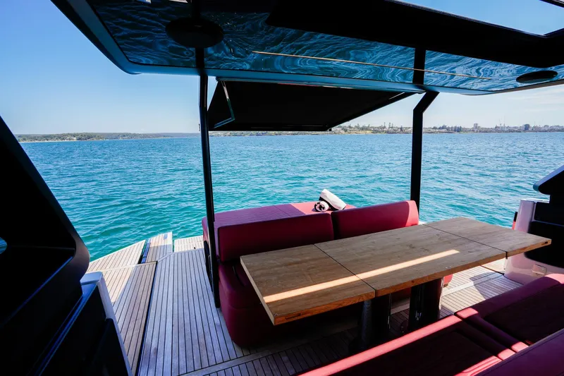  Yacht Photos Pics 2025 Cranchi A46 Luxury Tender with elegant seating and table, overlooking serene blue waters.