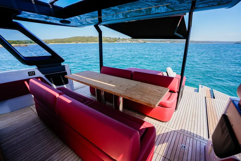  Yacht Photos Pics 2025 Cranchi A46 Luxury Tender with red seating and wooden table on open deck.